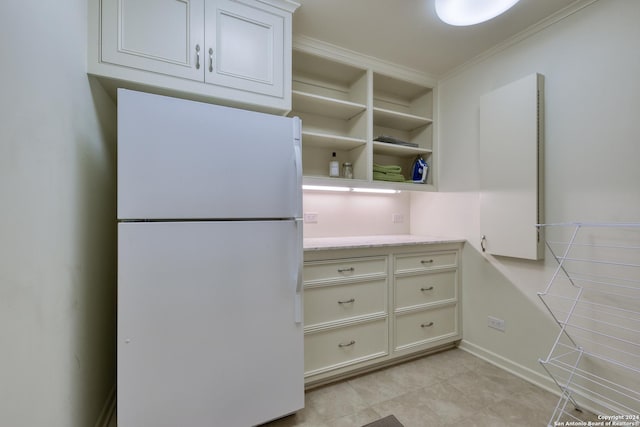 kitchen with crown molding, freestanding refrigerator, and open shelves