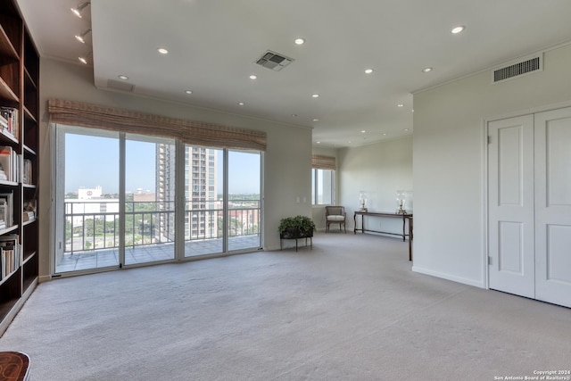 unfurnished living room featuring recessed lighting, visible vents, and carpet floors