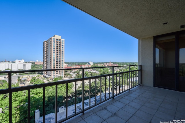 balcony featuring a city view and visible vents