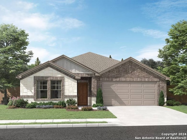 view of front of property featuring a garage and a front yard