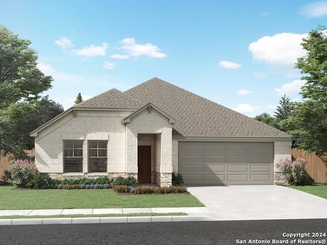 view of front of house featuring a garage and a front lawn