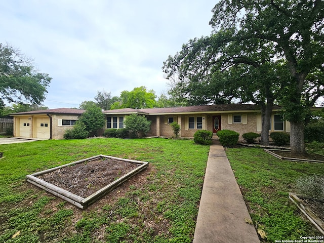 ranch-style home featuring a garage and a front lawn