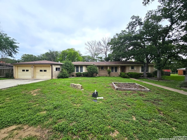 single story home featuring a front lawn and a garage