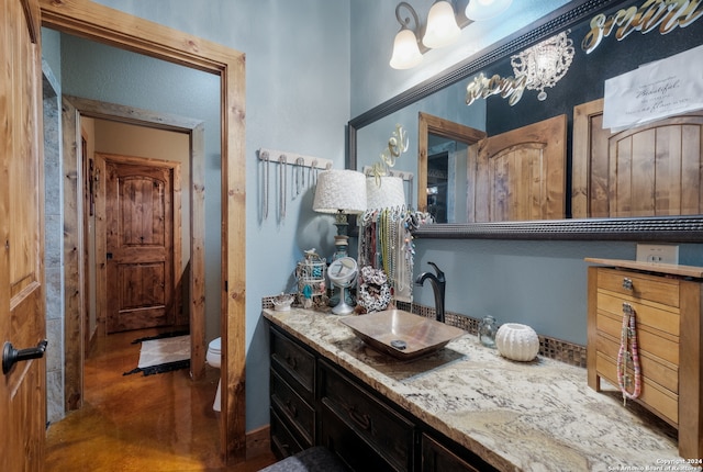 bathroom featuring toilet and oversized vanity