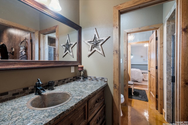 bathroom featuring toilet and vanity