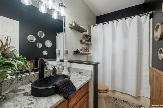 full bathroom with vanity, toilet, tile floors, and shower / tub combo