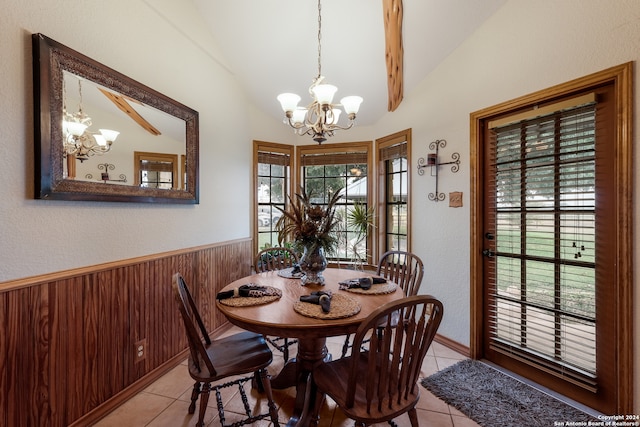 tiled dining room featuring lofted ceiling with beams and an inviting chandelier