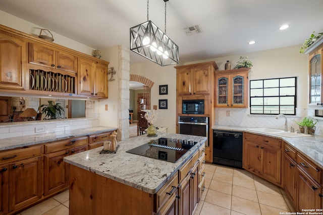 kitchen featuring backsplash, hanging light fixtures, black appliances, and light tile floors