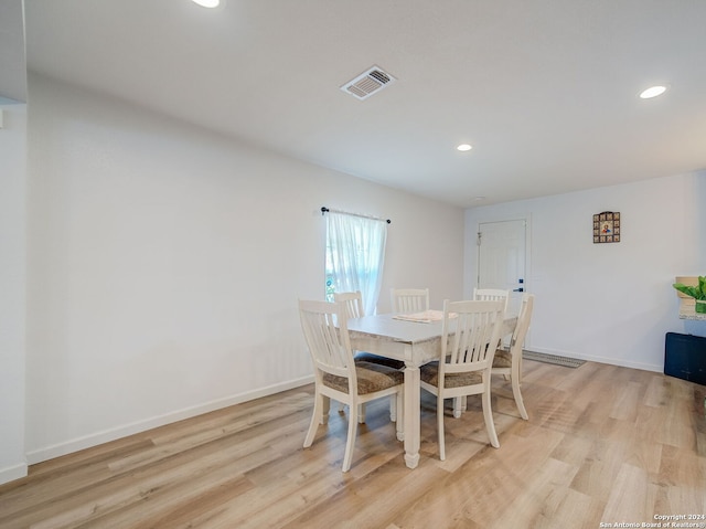 dining space with light hardwood / wood-style floors