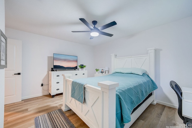 bedroom with ceiling fan and light hardwood / wood-style flooring