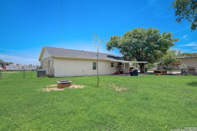 back of house featuring a lawn and a patio