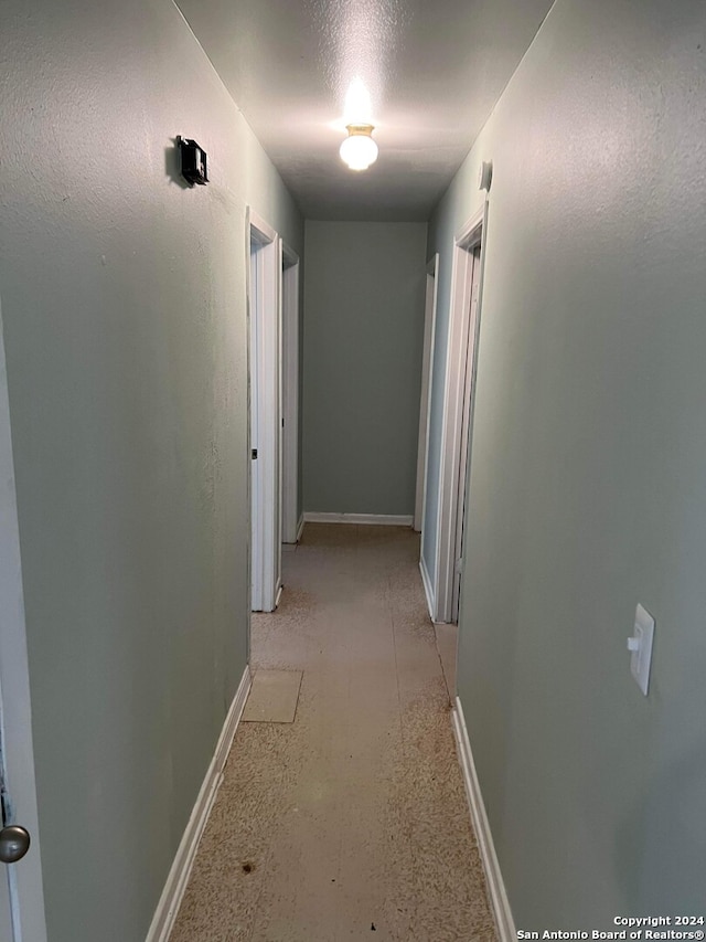 corridor featuring a textured ceiling