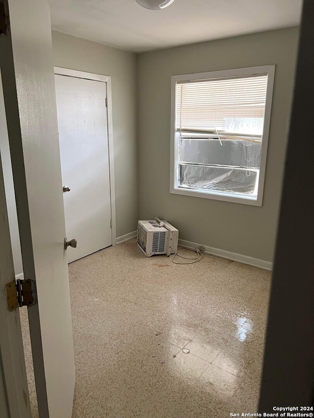 spare room featuring an AC wall unit