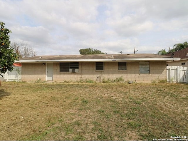 rear view of property with a lawn