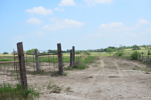 view of gate with a rural view