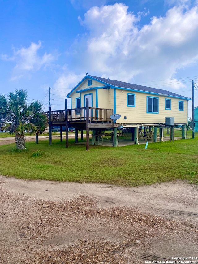 manufactured / mobile home with a deck and a front lawn