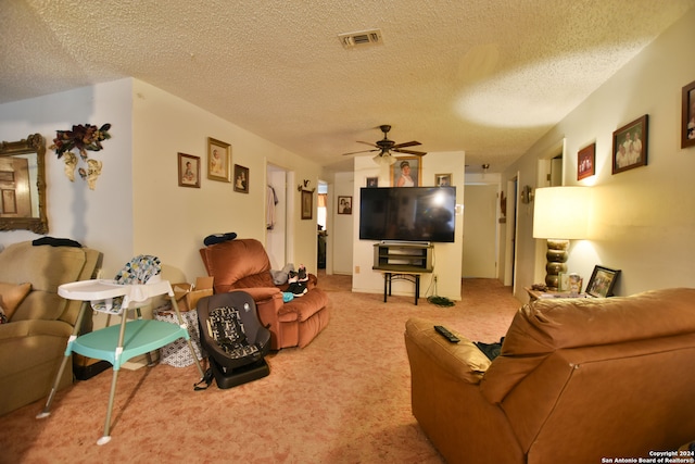 carpeted living room with a textured ceiling and ceiling fan