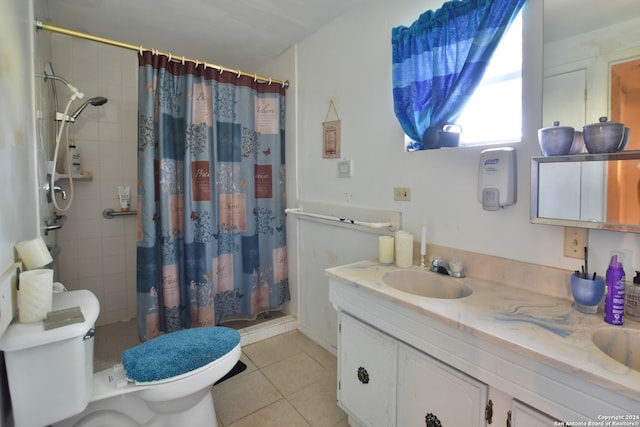 bathroom featuring tile flooring, vanity with extensive cabinet space, and toilet