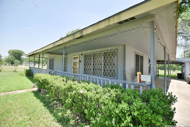 view of side of property with a lawn