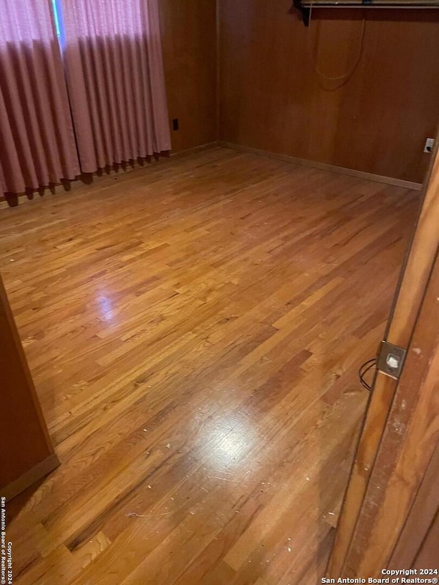 unfurnished room with radiator and light hardwood / wood-style flooring