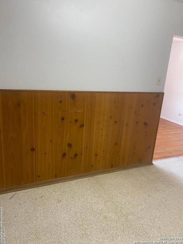 spare room with wood walls