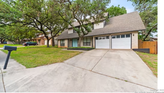 view of front facade with a garage and a front lawn