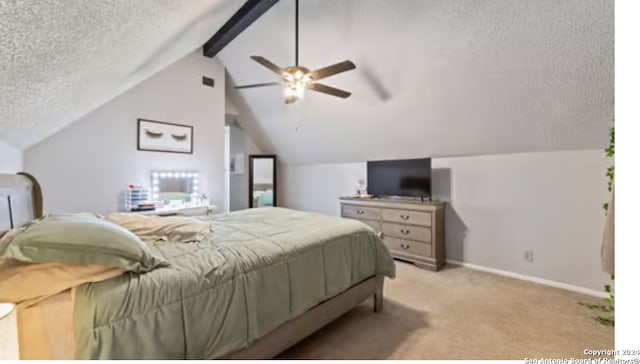 bedroom featuring a textured ceiling, lofted ceiling with beams, ceiling fan, and light colored carpet