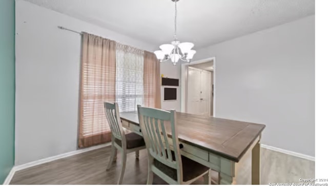 dining space featuring a chandelier and wood-type flooring