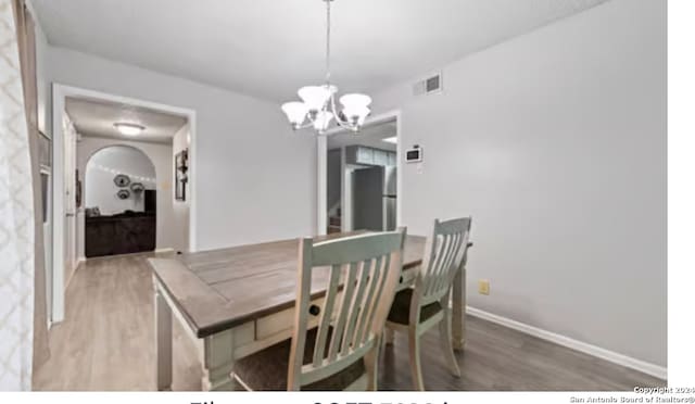 dining room with a notable chandelier and hardwood / wood-style floors