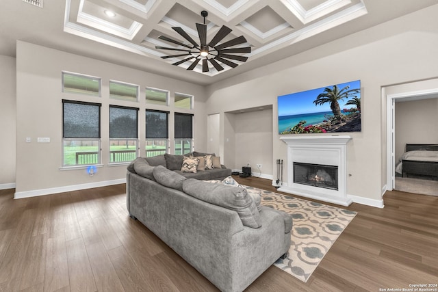 living room featuring dark hardwood / wood-style floors, coffered ceiling, and beam ceiling