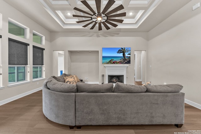 living room featuring crown molding, coffered ceiling, and hardwood / wood-style floors