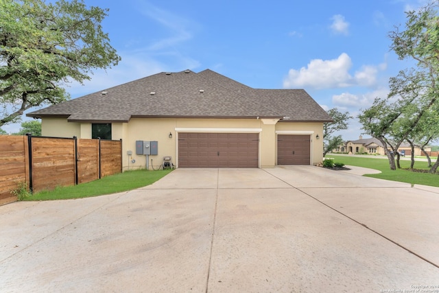 view of side of home with a garage and a lawn