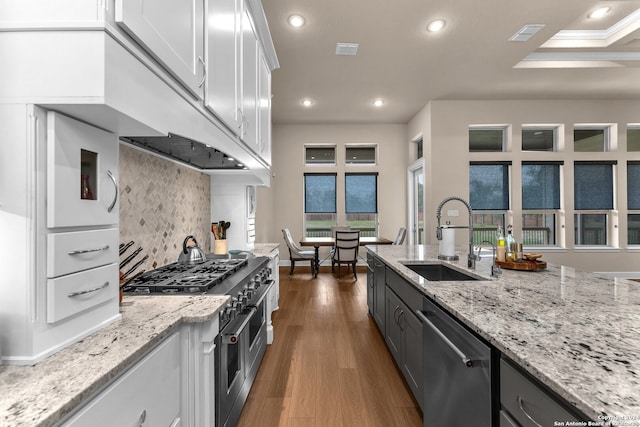 kitchen featuring white cabinetry, crown molding, appliances with stainless steel finishes, hardwood / wood-style floors, and sink