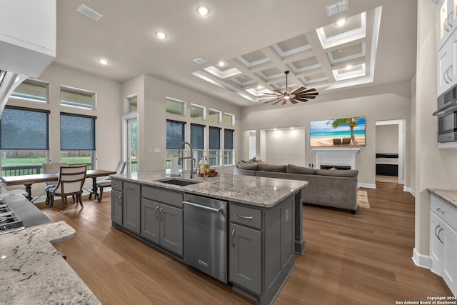 kitchen featuring hardwood / wood-style floors, beam ceiling, dishwasher, coffered ceiling, and sink