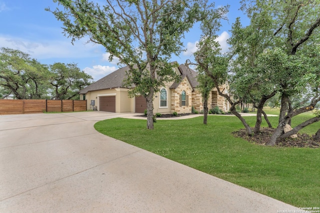 view of front of house with a garage and a front yard