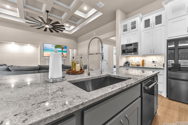 kitchen with coffered ceiling, light hardwood / wood-style floors, tasteful backsplash, white cabinetry, and beamed ceiling