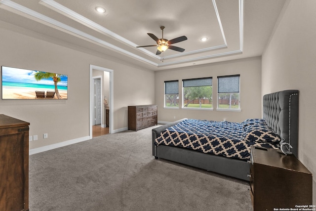 bedroom featuring carpet flooring, ornamental molding, ceiling fan, and a raised ceiling