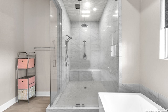 bathroom featuring tile floors and independent shower and bath