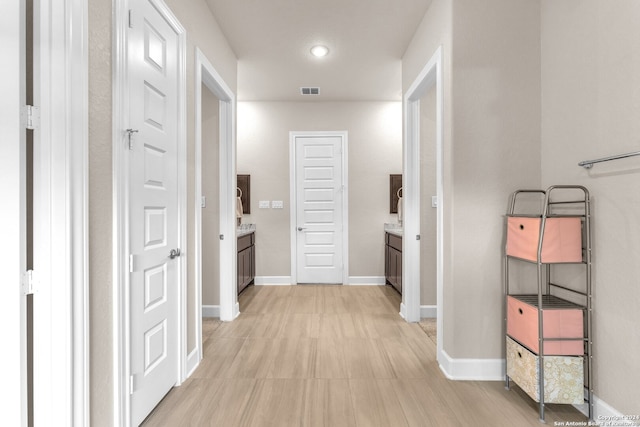 hall featuring light tile flooring