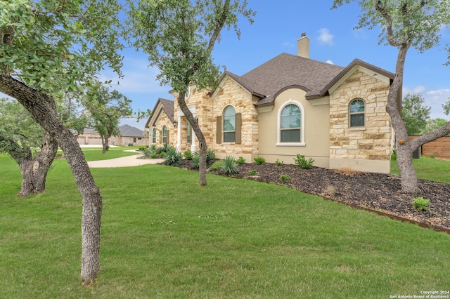 french provincial home featuring a front yard