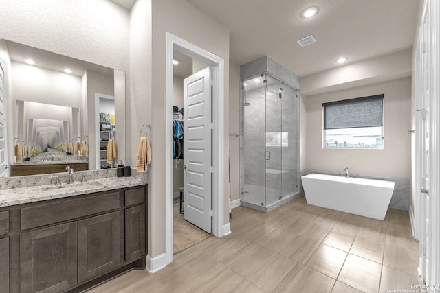 bathroom featuring tile flooring, an enclosed shower, and vanity