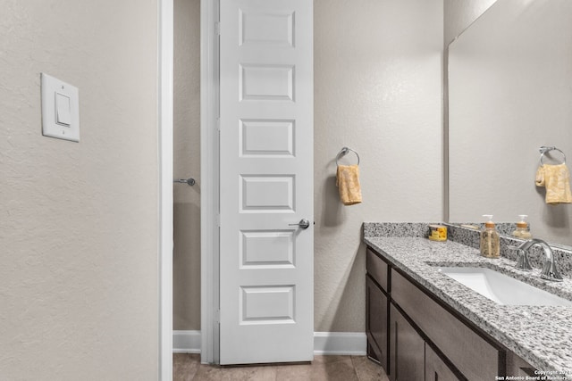 bathroom with tile flooring and vanity