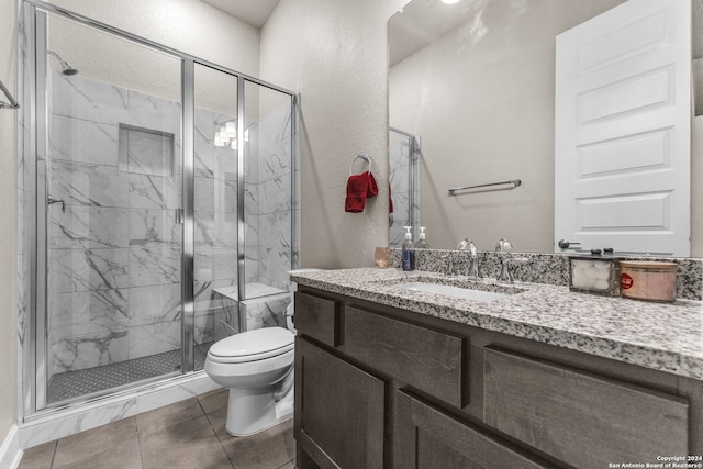 bathroom with tile flooring, an enclosed shower, toilet, and vanity