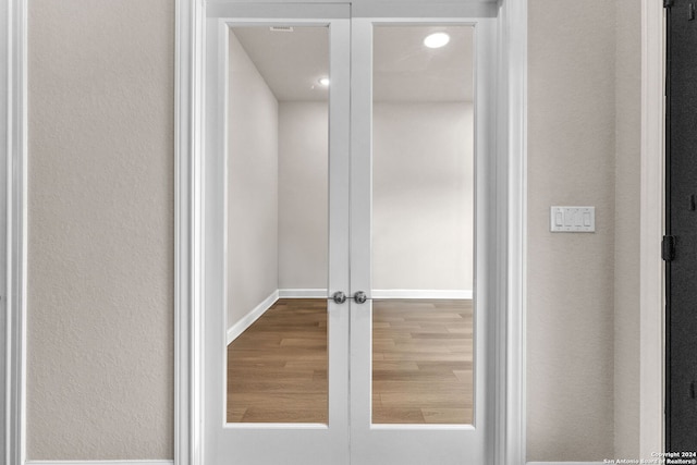 interior details with french doors and hardwood / wood-style floors