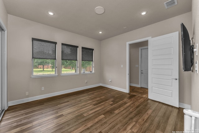 empty room with dark wood-type flooring