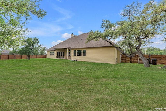 rear view of house with a yard