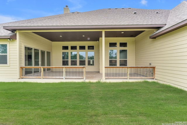 rear view of house with a lawn