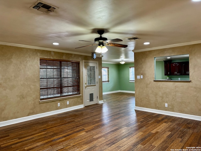 unfurnished living room with dark hardwood / wood-style flooring, ornamental molding, and ceiling fan