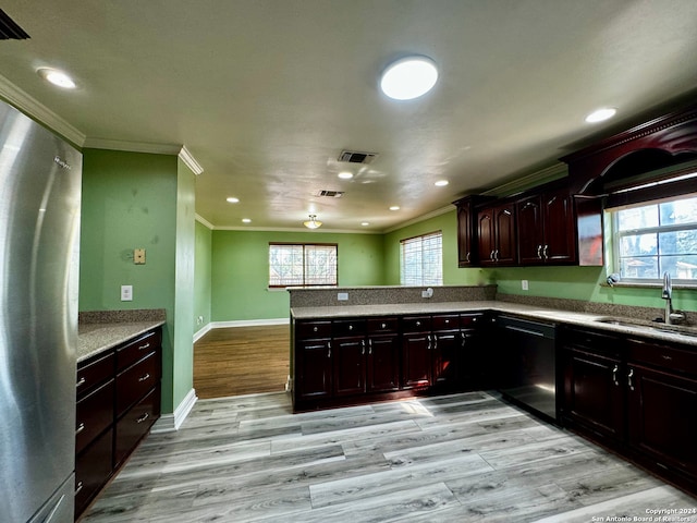 kitchen with kitchen peninsula, a healthy amount of sunlight, black dishwasher, and light hardwood / wood-style floors