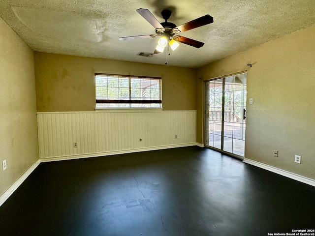 spare room with a textured ceiling and ceiling fan